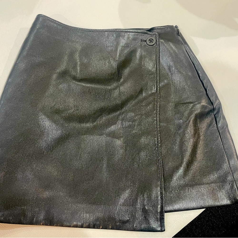 This is a high-waisted mini wrap skirt with a darted back for shaping